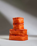 a stack of orange bags