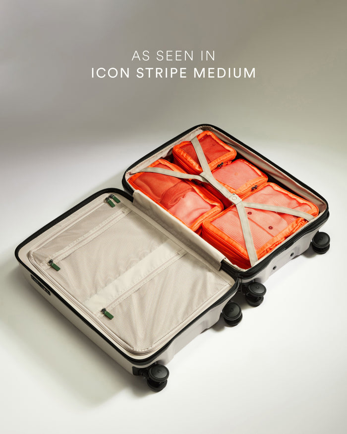 a suitcase with orange and white objects on wheels
