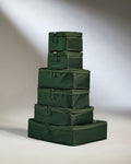 a stack of green luggage bags