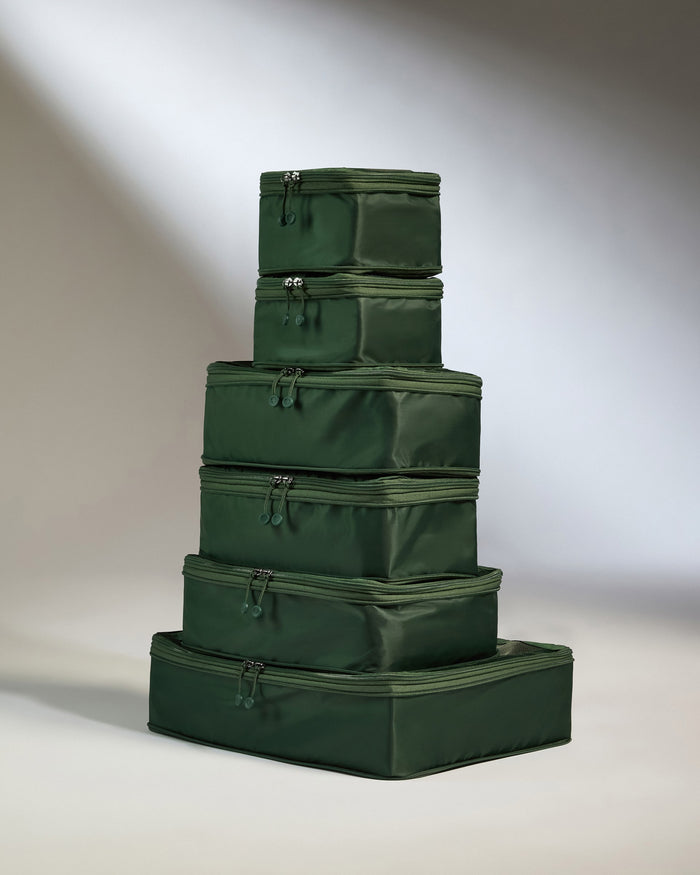 a stack of green luggage bags