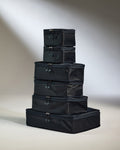 a stack of black luggage bags