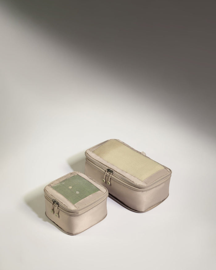 two small bags on a white surface