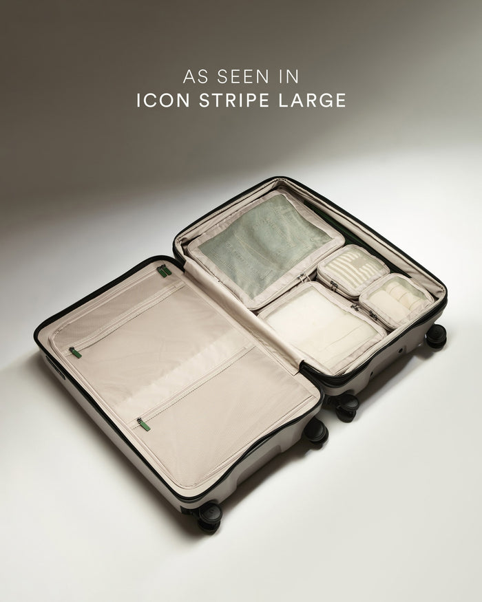 a suitcase with wheels and a few objects inside