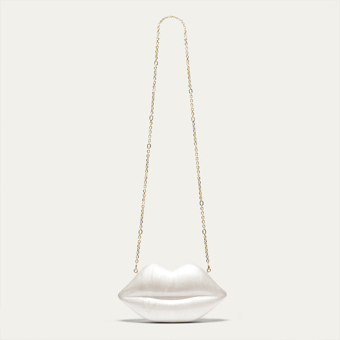 Lip-shaped handbag with a chain strap on a light gray background
