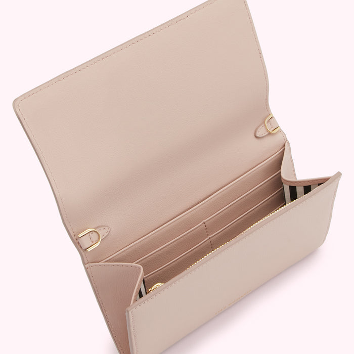 A blush pink leather wallet on a white background, open to show multiple card slots and a zippered compartment.