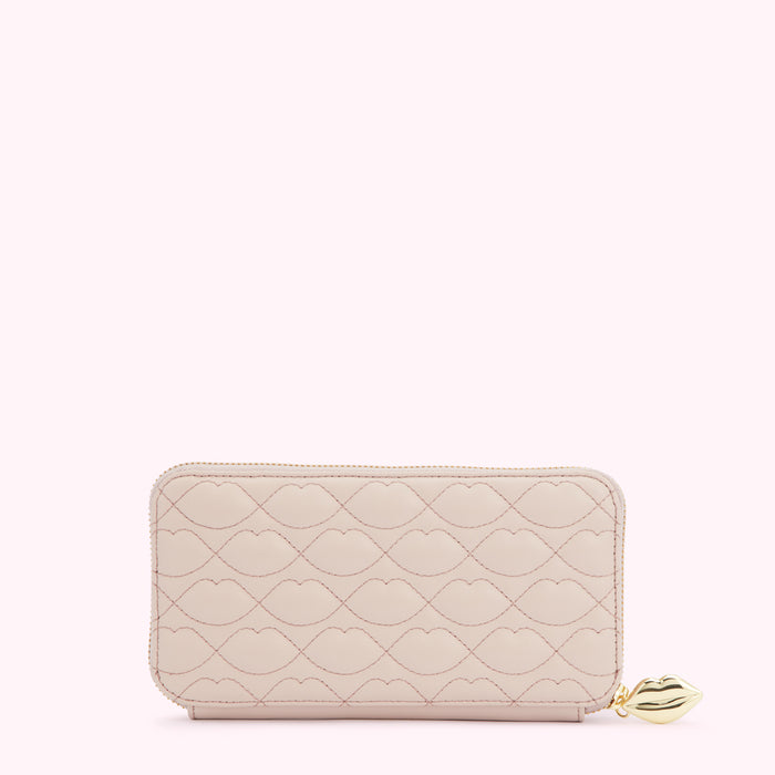 Pink quilted zip-around wallet with lip pattern and gold lip zipper pull.