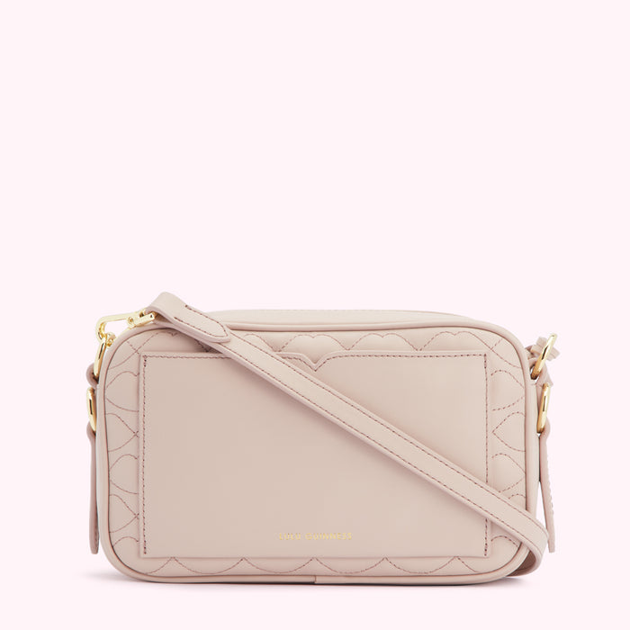 Light pink quilted crossbody bag with gold hardware.