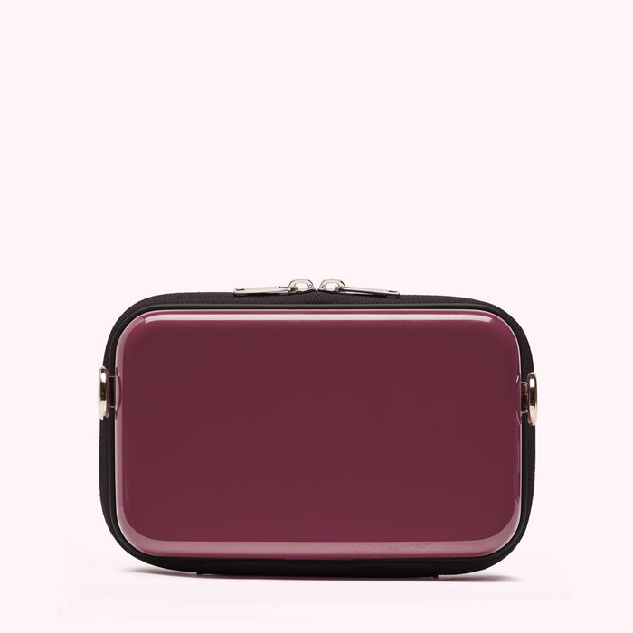Burgundy coloured rectangular bag with black zipper and trim.