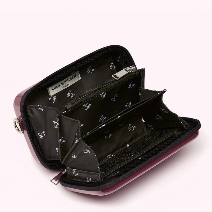 Open purple Lulu Guinness purse showing interior details and compartments.