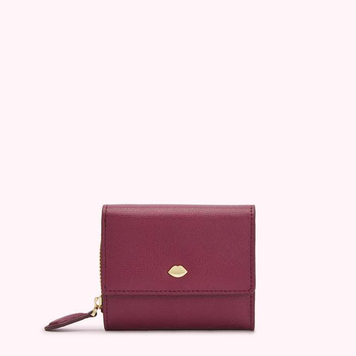 A burgundy leather wallet with a gold lip-shaped detail on a white background.
