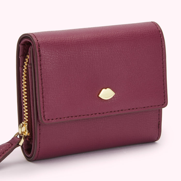Burgundy leather wallet with gold zipper and lip-shaped detail.