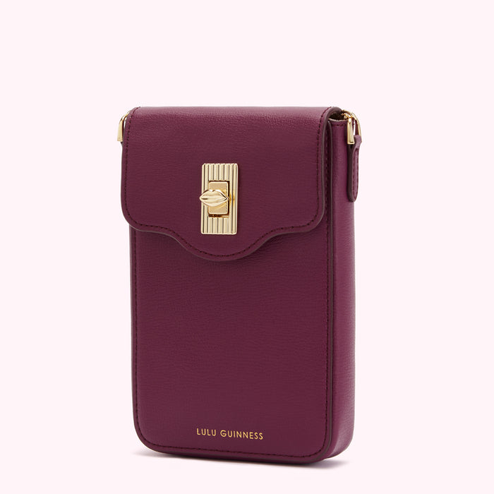 Burgundy Lulu Guinness crossbody phone bag with gold clasp.