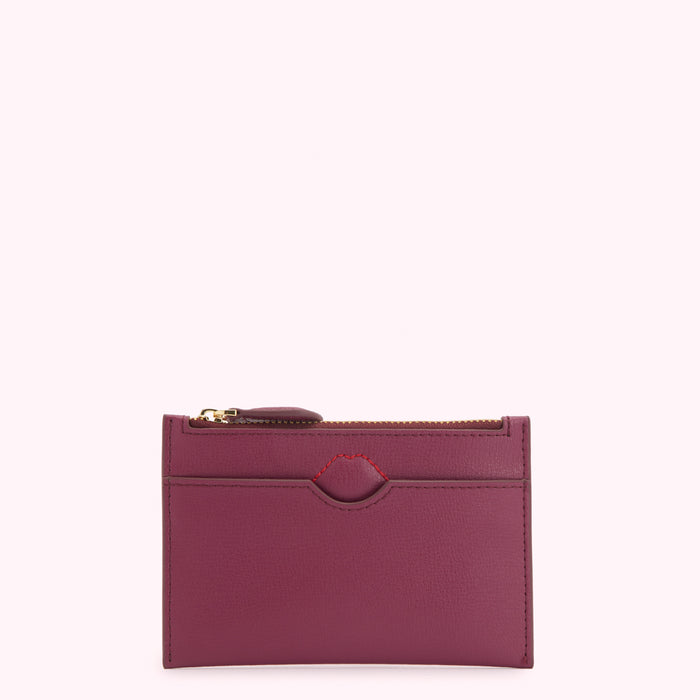 Purple leather card holder with gold zipper.