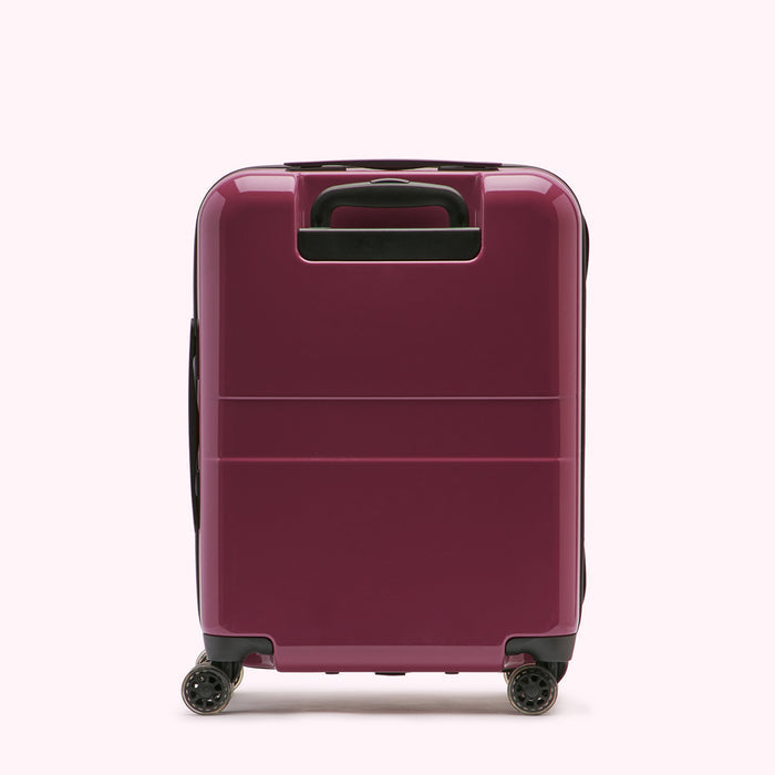 A dark burgundy hard-shell suitcase standing upright on a white background.