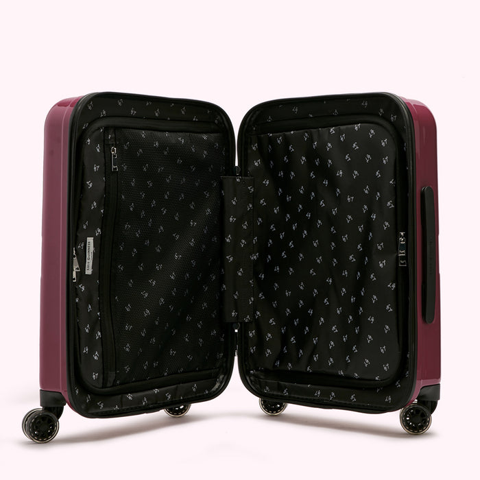Open maroon suitcase with black patterned interior lining.