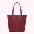 Burgundy quilted tote bag with clear handles and lip print pattern.