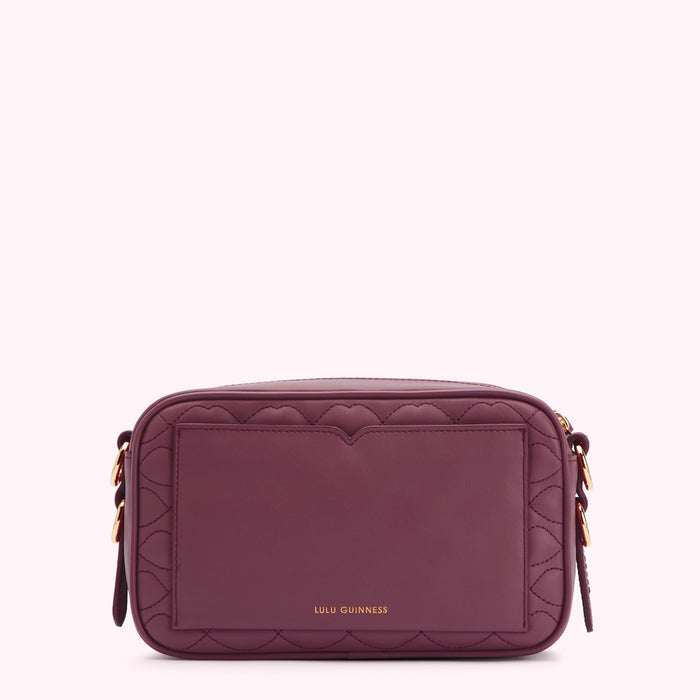 Purple quilted crossbody bag with gold hardware and Lulu Guinness logo.