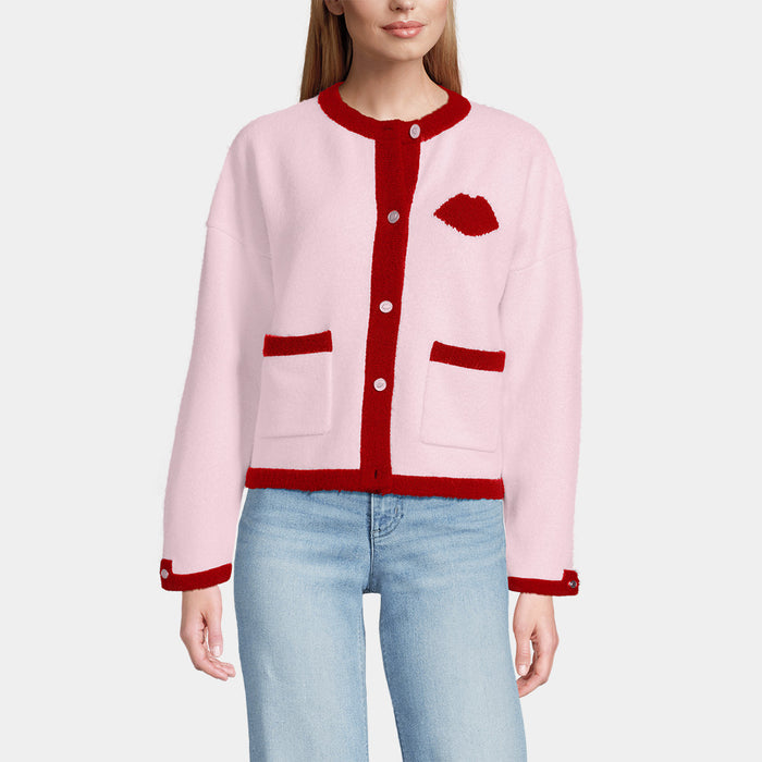 Pink cardigan with red trim and knitted lip details on a white background