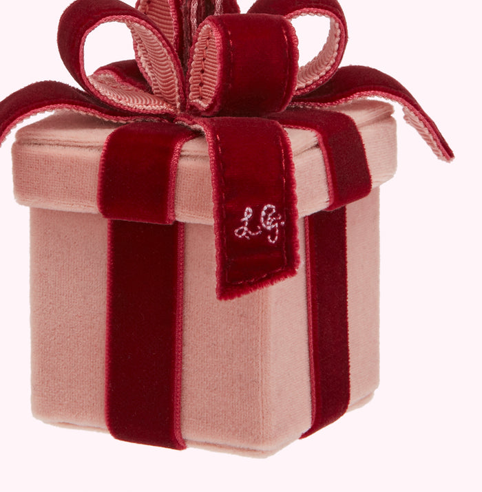 Pink velvet gift box with a burgundy velvet ribbon and bow; the initials "LG" are embroidered on the box.