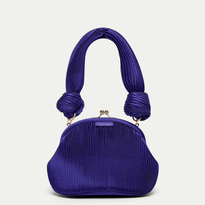Purple pleated satin handbag with a shoulder handle on a light gray background