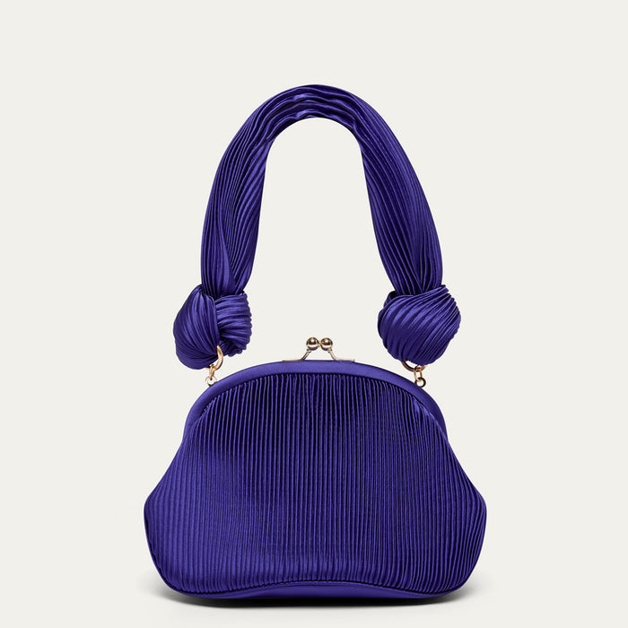 Purple pleated satin handbag with knotted shoulder handles on a light gray background