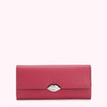Pink leather wallet with a silver lip-shaped clasp against a white background.