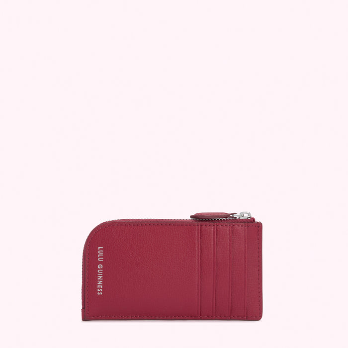 Red leather cardholder with silver zipper and Lulu Guinness logo.
