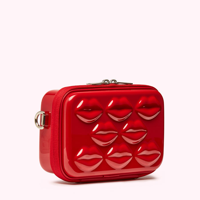Red crossbody bag with lips design.