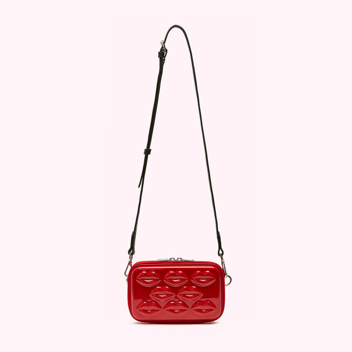 Red crossbody bag with a lip pattern.