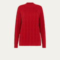 Red cable knit sweater on a light beige background