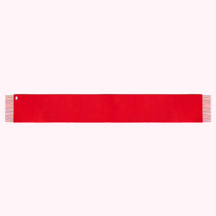 A long, solid red scarf with frayed ends and a small hole near one end, isolated on a white background.