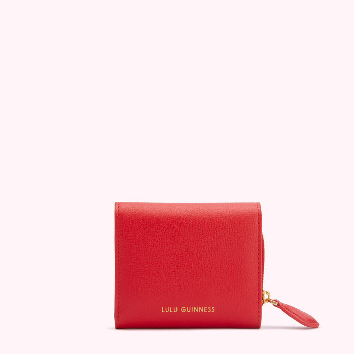 Red Lulu Guinness wallet on white background.