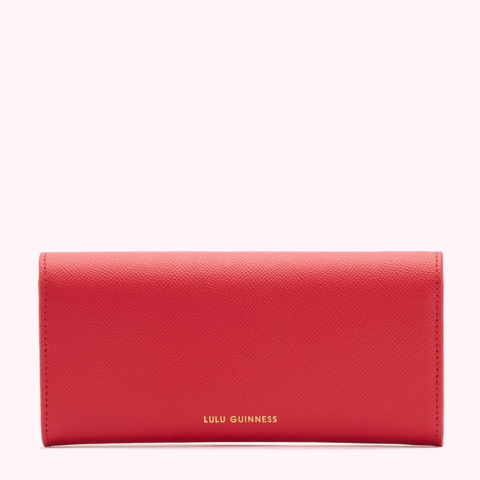 Red Lulu Guinness wallet against a white background.