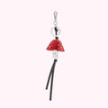 Red leather mushroom-shaped keychain with silver-toned metal details and black leather tassels.