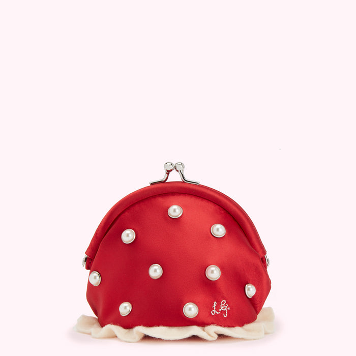 Red satin coin purse with pearl accents and cream trim against a white background.