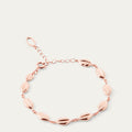 Rose gold lip chain bracelet on a light gray background