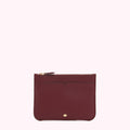 Burgundy leather zip pouch on white background.