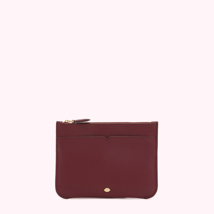 Burgundy leather zip pouch on white background.