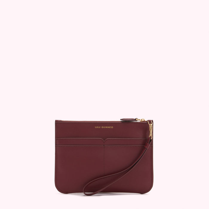 Burgundy leather Lulu Guinness zip-around clutch with wrist strap.