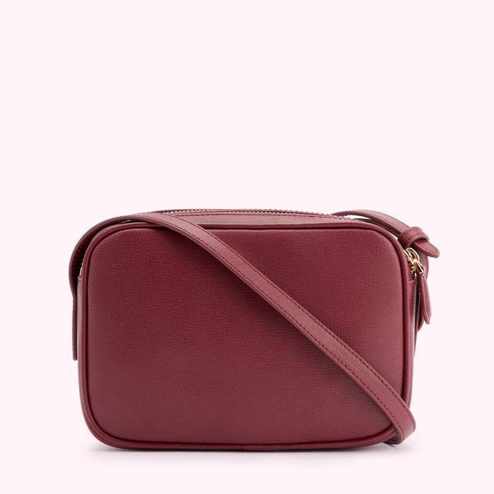 Burgundy leather crossbody bag with gold zipper and strap.