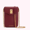 Burgundy Lulu Guinness crossbody bag with gold chain strap and clasp.