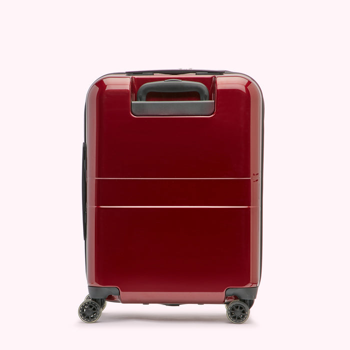 Red carry-on suitcase with black wheels and handle, shown from the back.