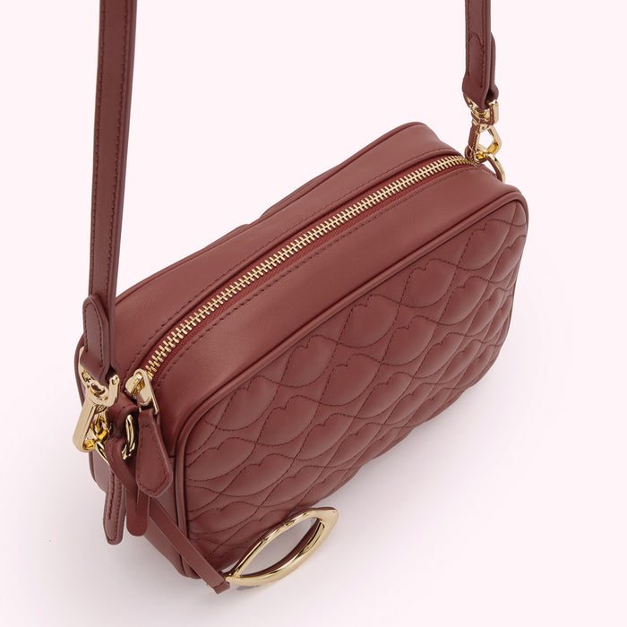 Brown quilted crossbody bag with gold-tone hardware.