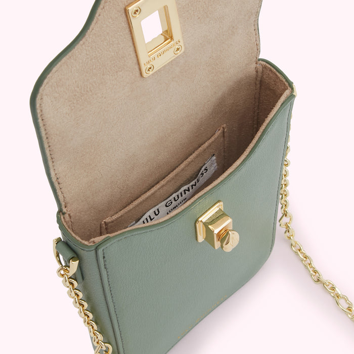 Sage green leather Lulu Guinness crossbody bag with gold hardware, shown open to reveal beige interior and brand label.