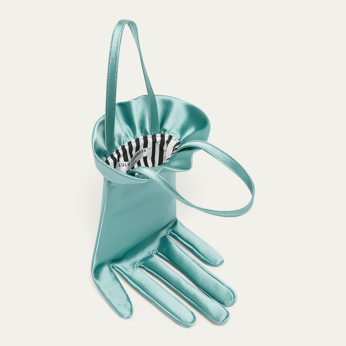 Turquoise satin hand-shaped handbag on a light gray background