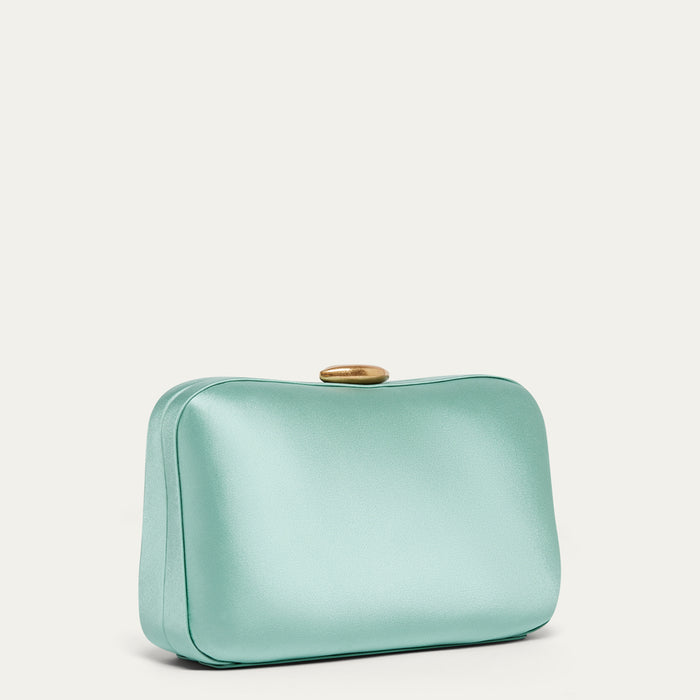 Mint green satin clutch bag on a light beige background