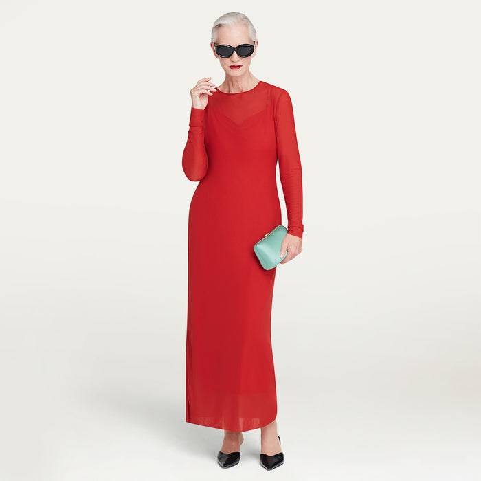 Woman in a red dress holding a light blue satin clutch against a white background