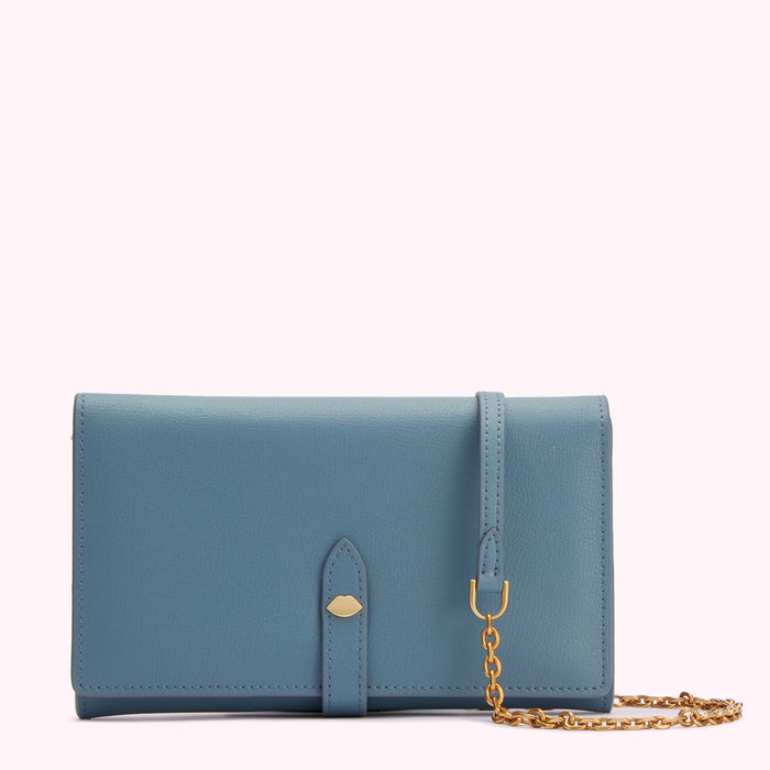 A blue leather wallet with a gold chain strap and a small gold lip-shaped emblem.