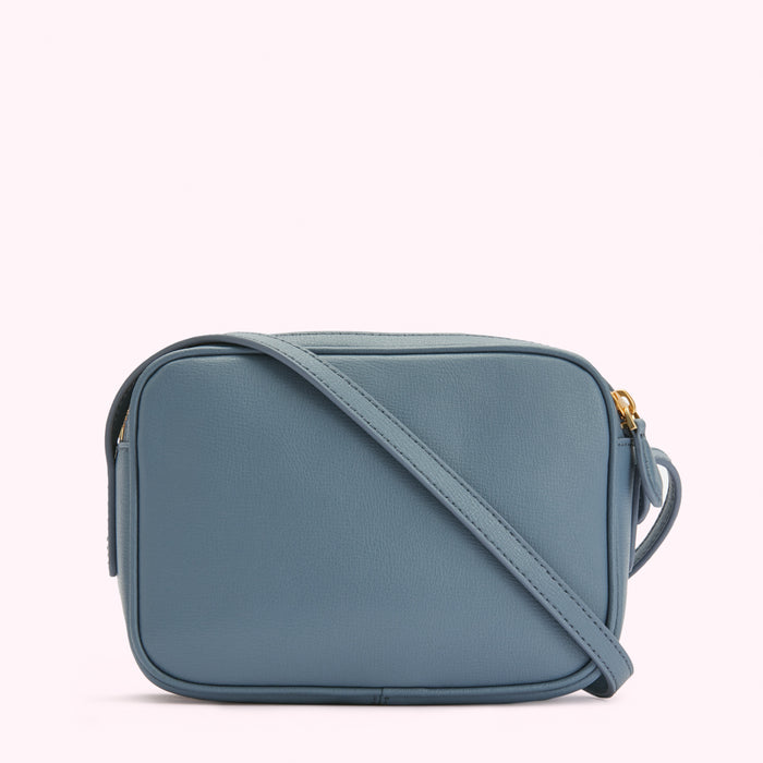 Dusty blue leather crossbody bag with gold zipper.