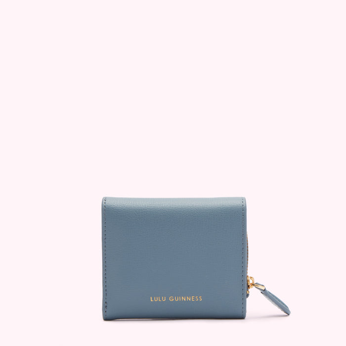 A powder blue Lulu Guinness zip-around wallet against a white background.